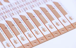 Row of peach raffle tickets with serial numbers and perforated edges