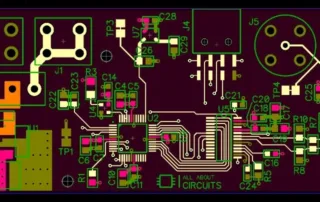 Top view of a populated PCB layout with a microcontroller, resistors, capacitors, connectors, and test points, showing green traces on a purple solder-mask board and silkscreen text.