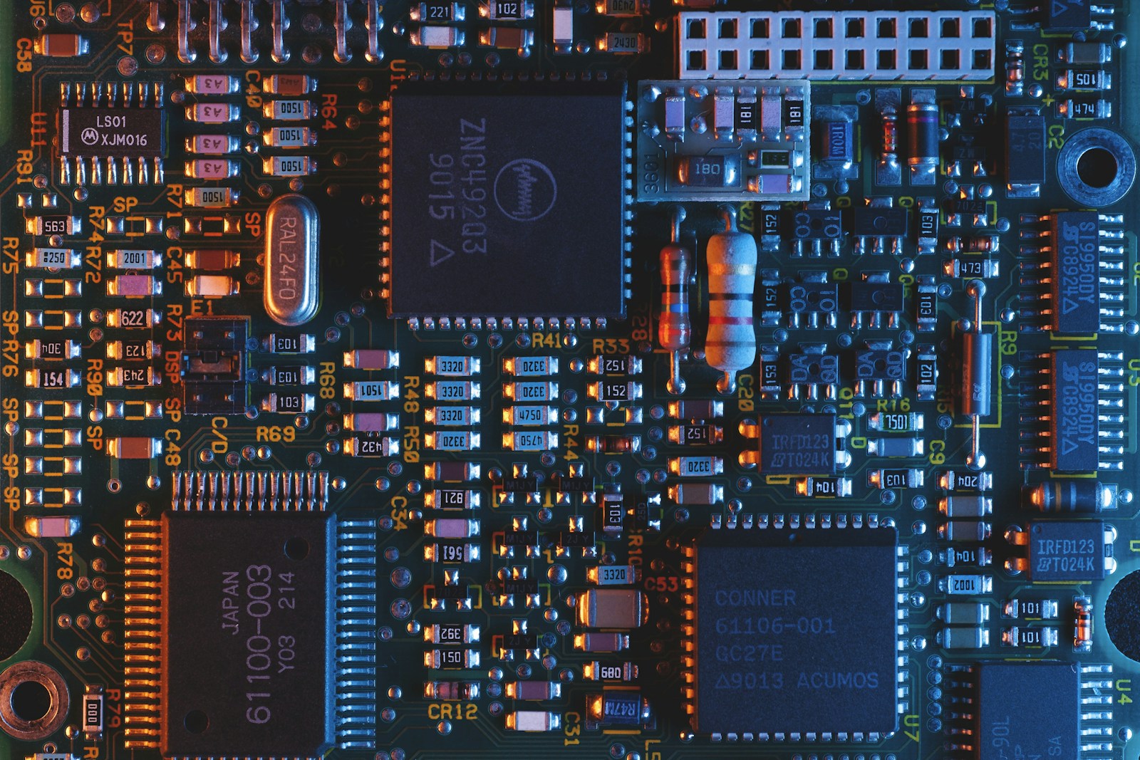 Close-up of integrated circuits and surface-mount components on a circuit board