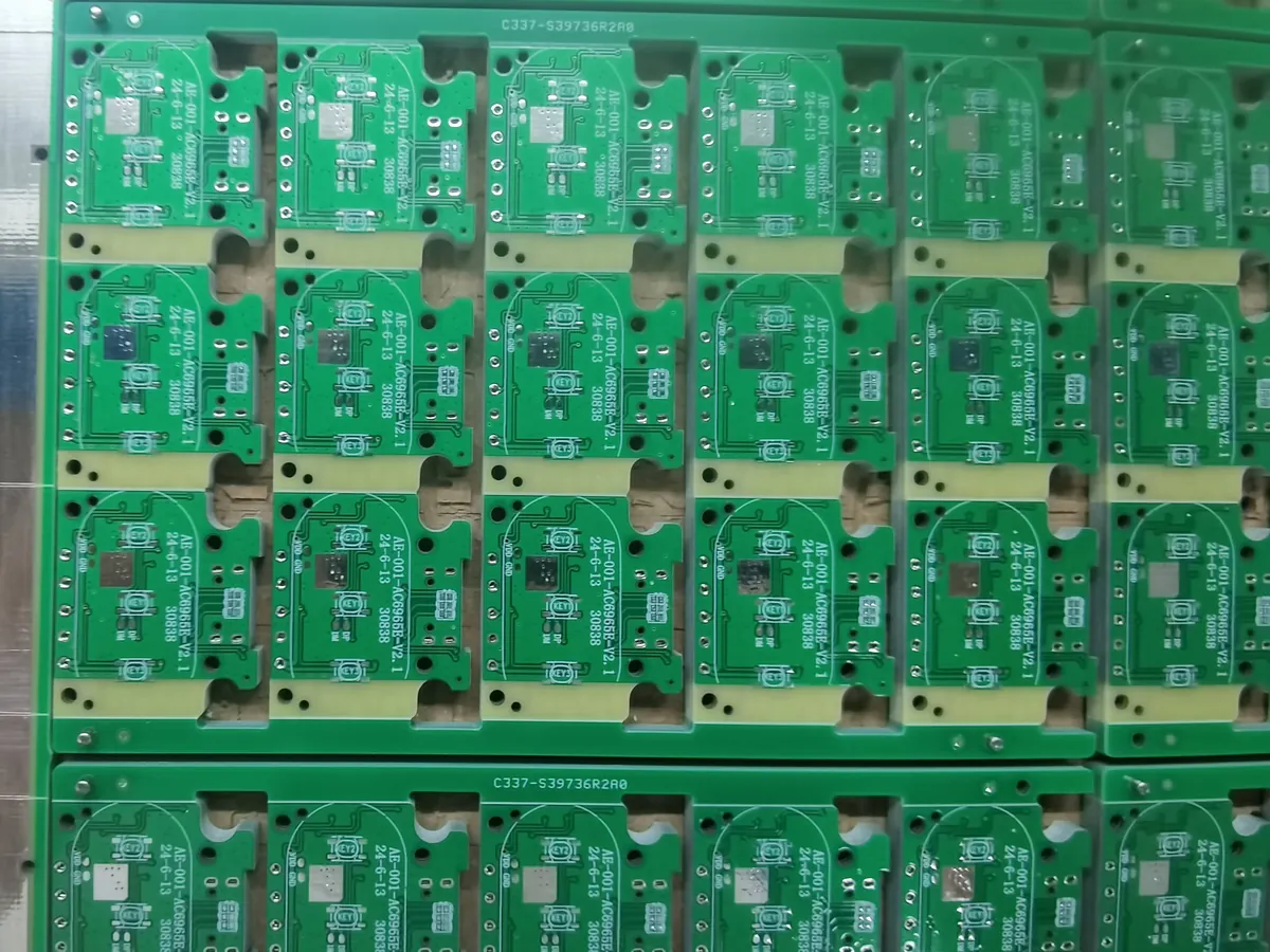 Repeated green PCB units connected within a larger panel with handling rails