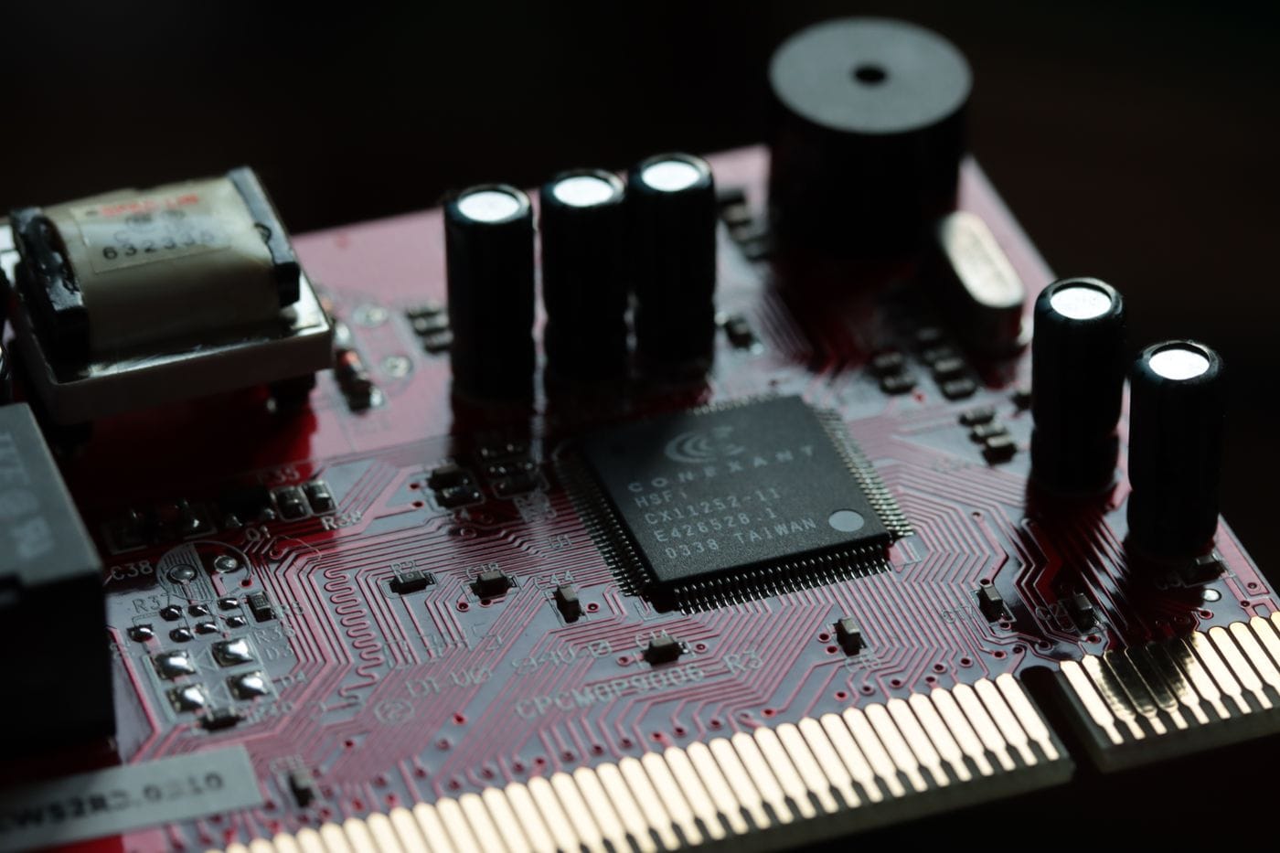 Close-up of a populated circuit board with integrated circuits and capacitors