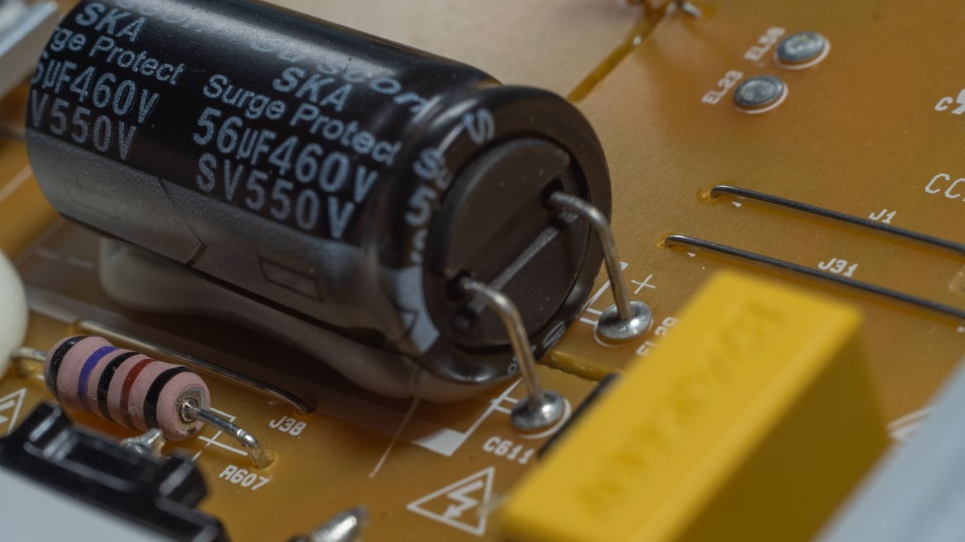 Close-up of a capacitor and resistor mounted on a circuit board