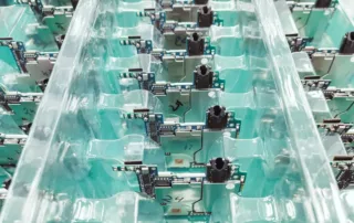 Assembled circuit boards arranged in rows on production fixtures