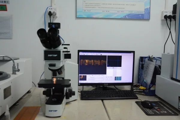 Microscope and computer display at a PCB measurement and inspection workstation