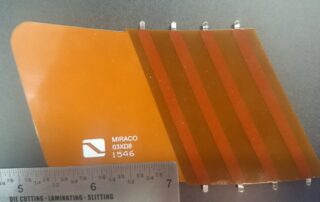 Real flexible printed circuit with amber coverlay, parallel conductors and exposed contact fingers