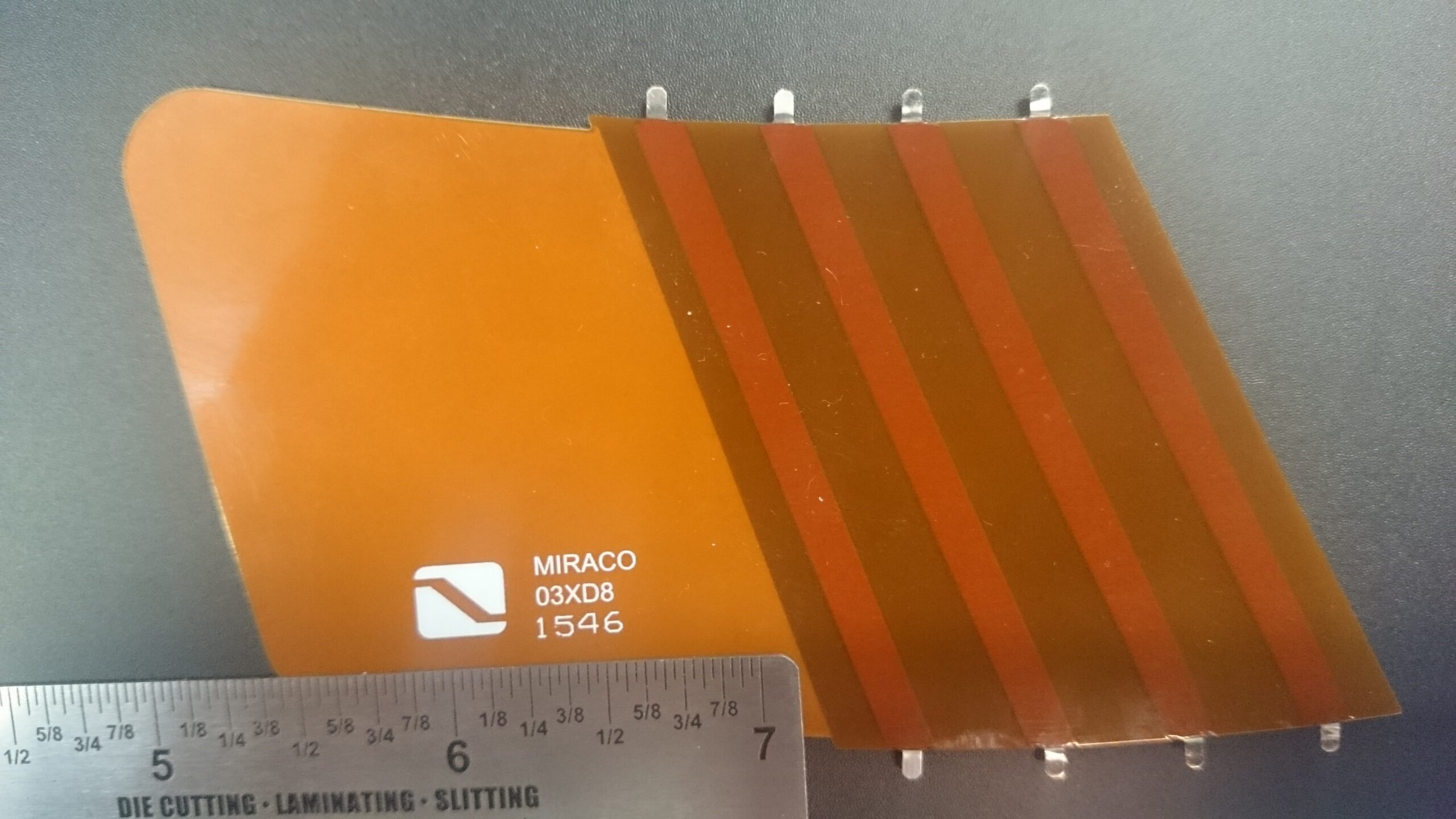 Real flexible printed circuit with amber coverlay, parallel conductors and exposed contact fingers